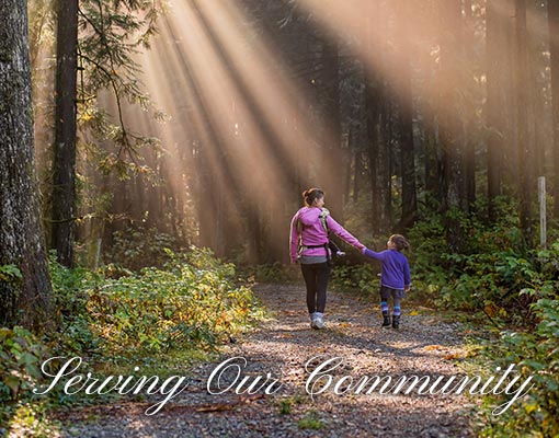 Mother and daughter walking on a forest path